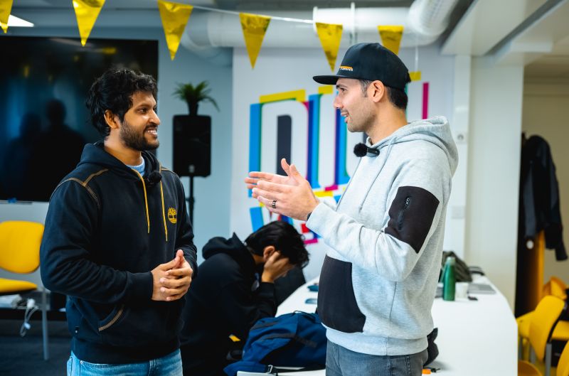 Ehsan Mohajer discussing a project with a collaborator